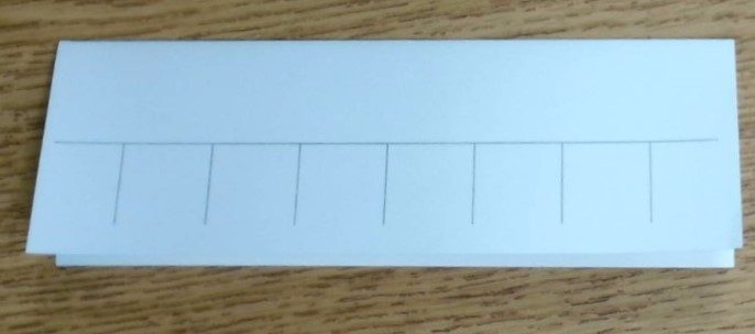 Index card folded backward along the first line